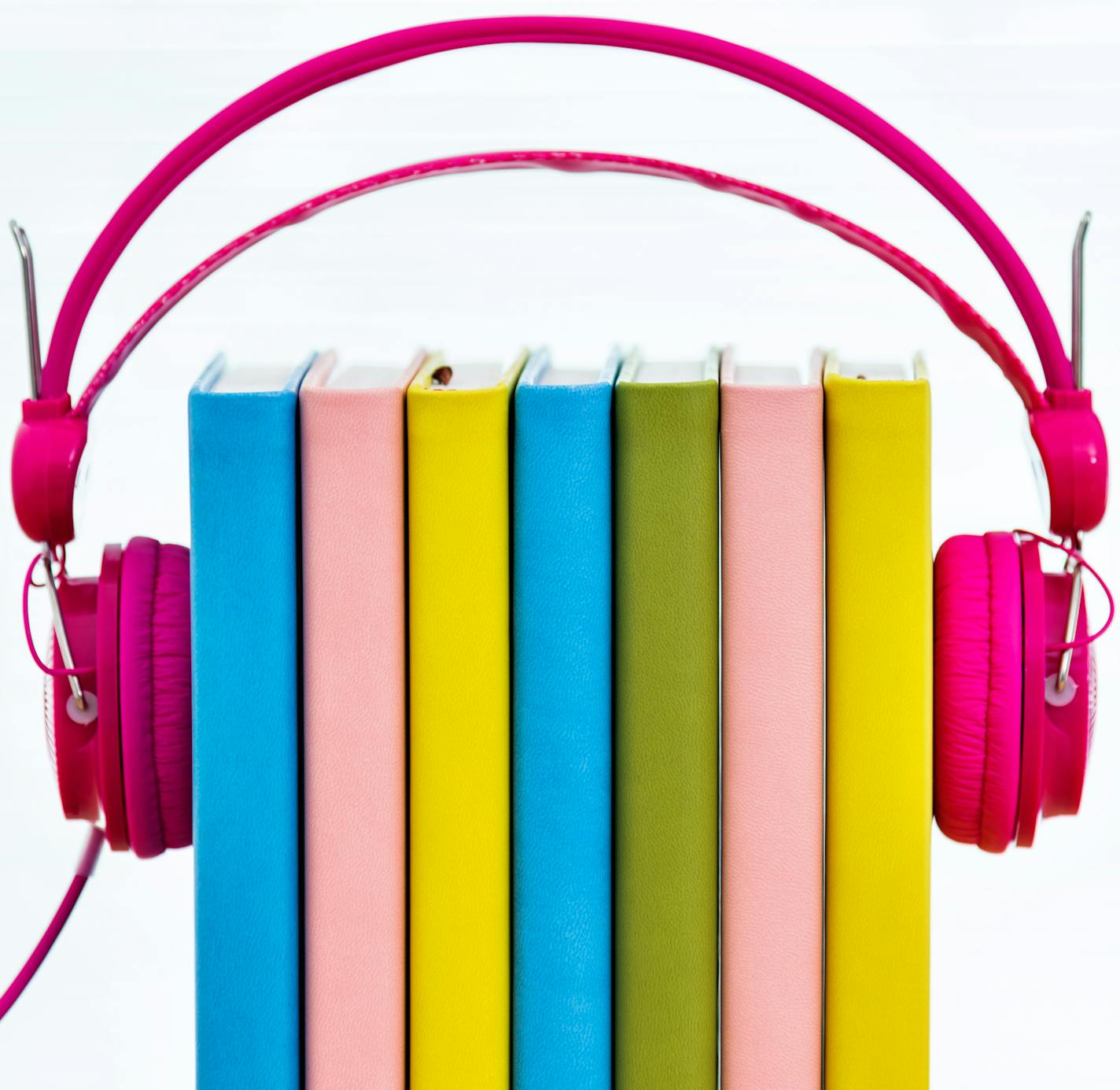 Group of books in headphones, isolated on white background. istock