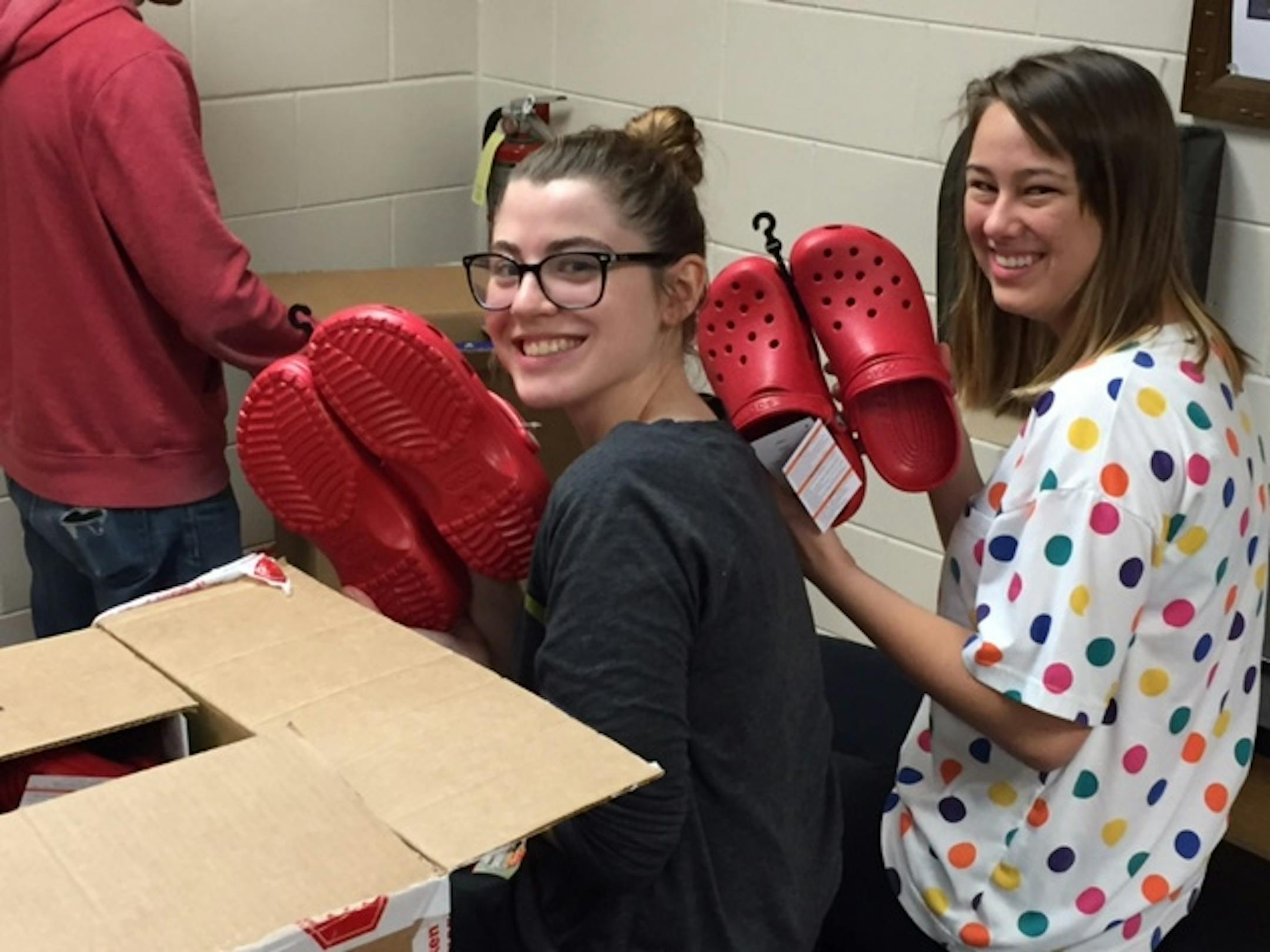 Lilly McLaughlin (left) and Cornelia Lutz came up with the idea to wear Crocs to prom. The idea was criticized at first but news of free footwear won students over