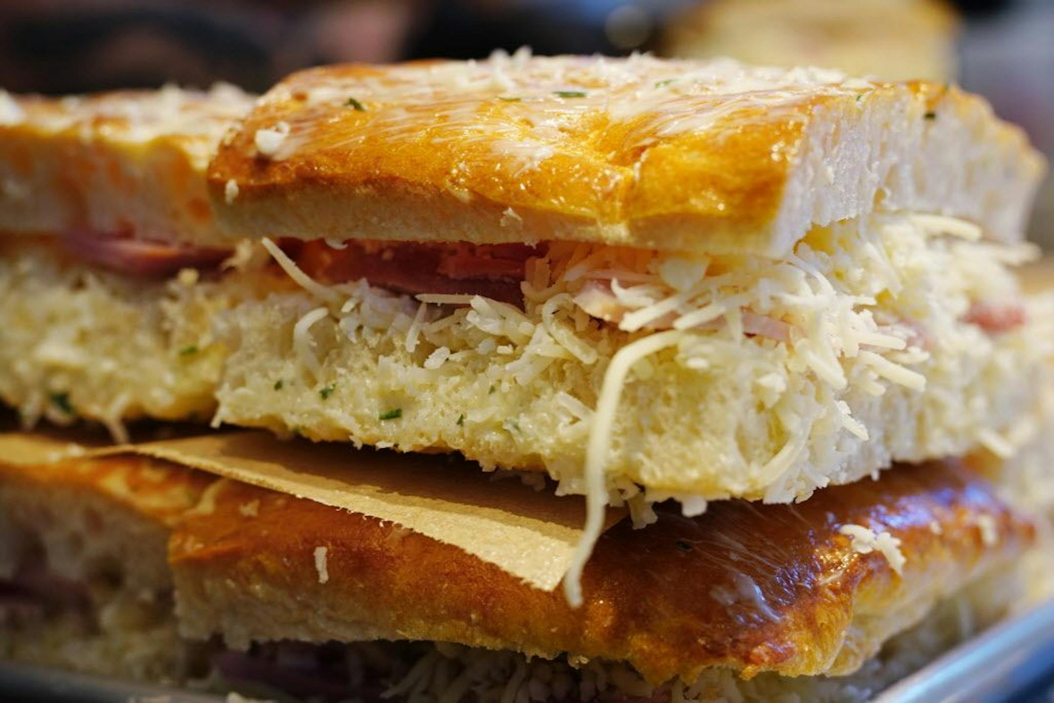 Sous chef Jasmine Weiser reapers some ham and gruyere panini.