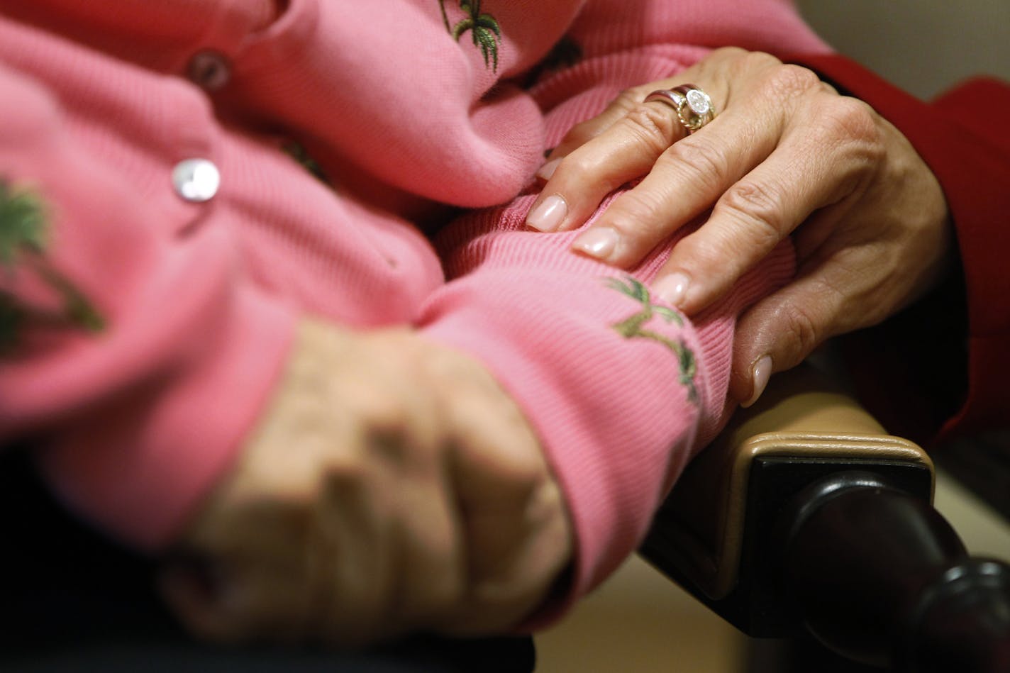 Alexis McKenzie, right, executive director of The Methodist Home of the District of Columbia Forest Side, an Alzheimer's assisted-living facility in Washington, puts her hand on the arm of a resident.