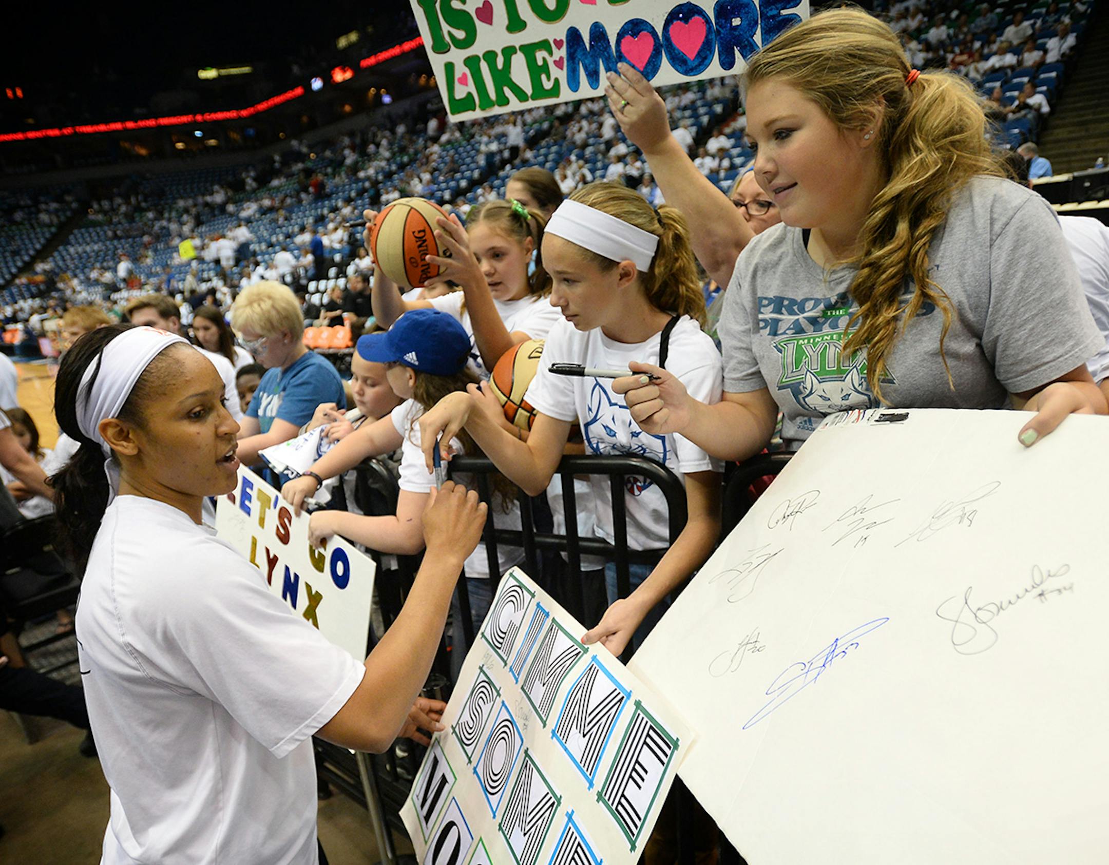 Minnesota Lynx forward Maya Moore (23) signed autographs for young fans before Wednesday's championship game against Indiana.