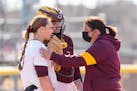 Gophers coach Piper Ritter, right, talked to one of her pitchers in 2021. This season Minnesota takes an eight-game winning streak into its last regul