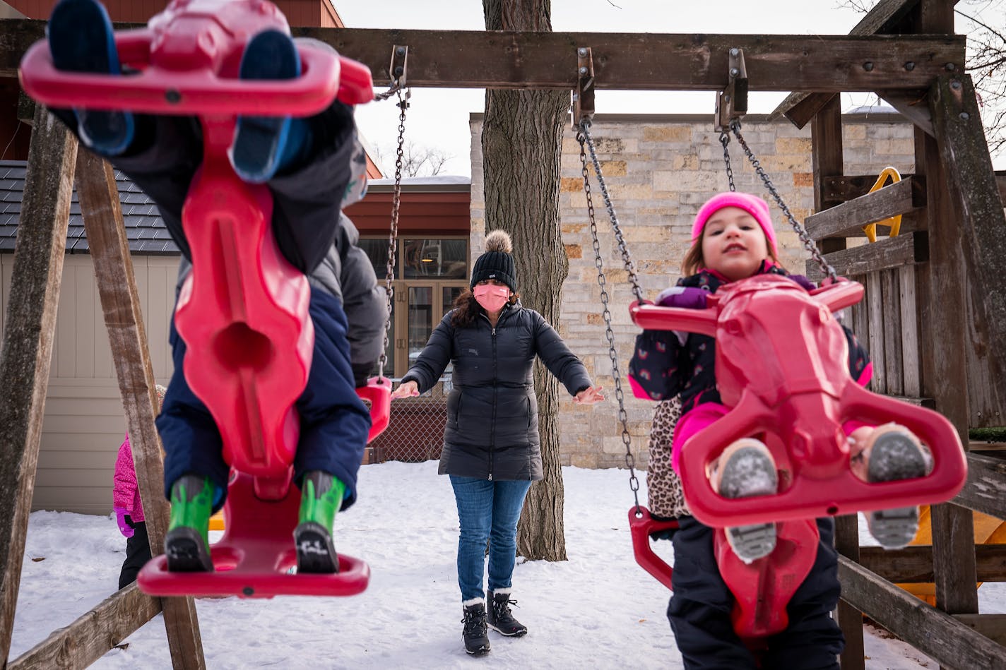 Teacher Alejandrina Orellana-Barerra, who has been vaccinated, helped push preschool children during outdoor time at Mis Amigos Spanish Immersion Preschool in Hopkins. ] LEILA NAVIDI • leila.navidi@startribune.com