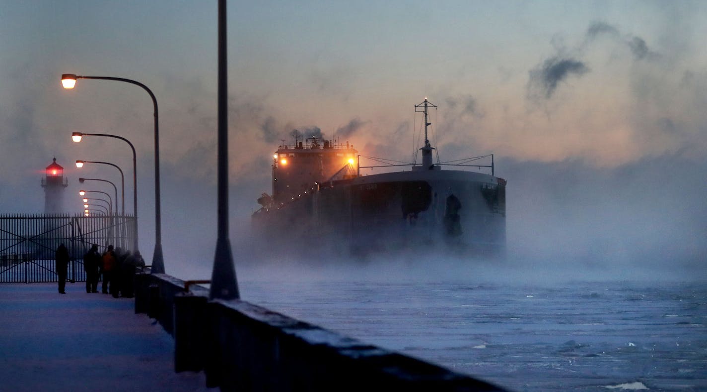 Steam rises from Lake Superior at the ship St. Clair comes to harbor during some of the coldest temps of the year Sunday, Dec. 31, 2017, at Canal Park in Duluth, MN. The St. Clair is a self-unloader built in 1976 at Sturgeon Bay, Wisconsin and is 770 feet long and has 26 hatches that open into 5 cargo holds, providing a load capacity of 45,000 tons. Numerous people braved the frigid temps to see and photograph the icy scene.] DAVID JOLES &#xef; david.joles@startribune.com People and ships endure