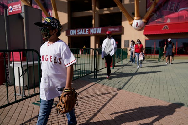Fans leave Angel Stadium when a baseball game between the Minnesota Twins and the Los Angeles Angels was postponed Saturday, April 17, 2021, in Anahei