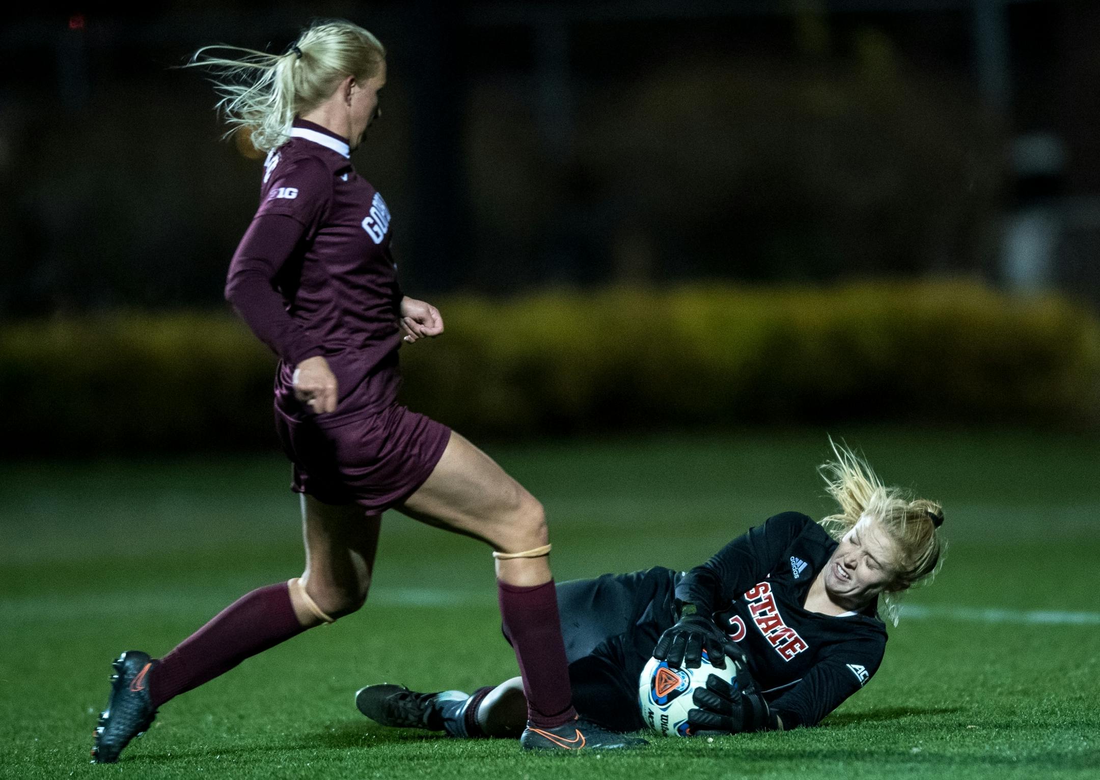 NC State goalkeeper Sydney Wootten (12) made a save on a shot by Minnesota forward Sydney Squires (7) Saturday night.