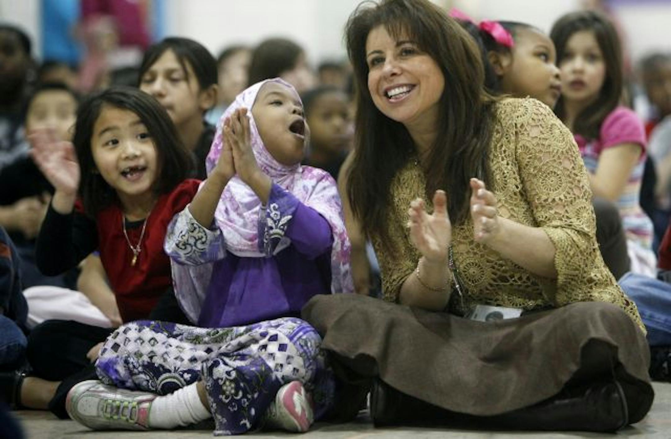 New St. Paul Superintendent Valeria Silva got to know kindergartner Qali Mohamed, center, and Alexis Xiong during a recent assembly at Eastern Heights Elementary School. Silva has spent 20 years in the district as a teacher, principal and administrator.