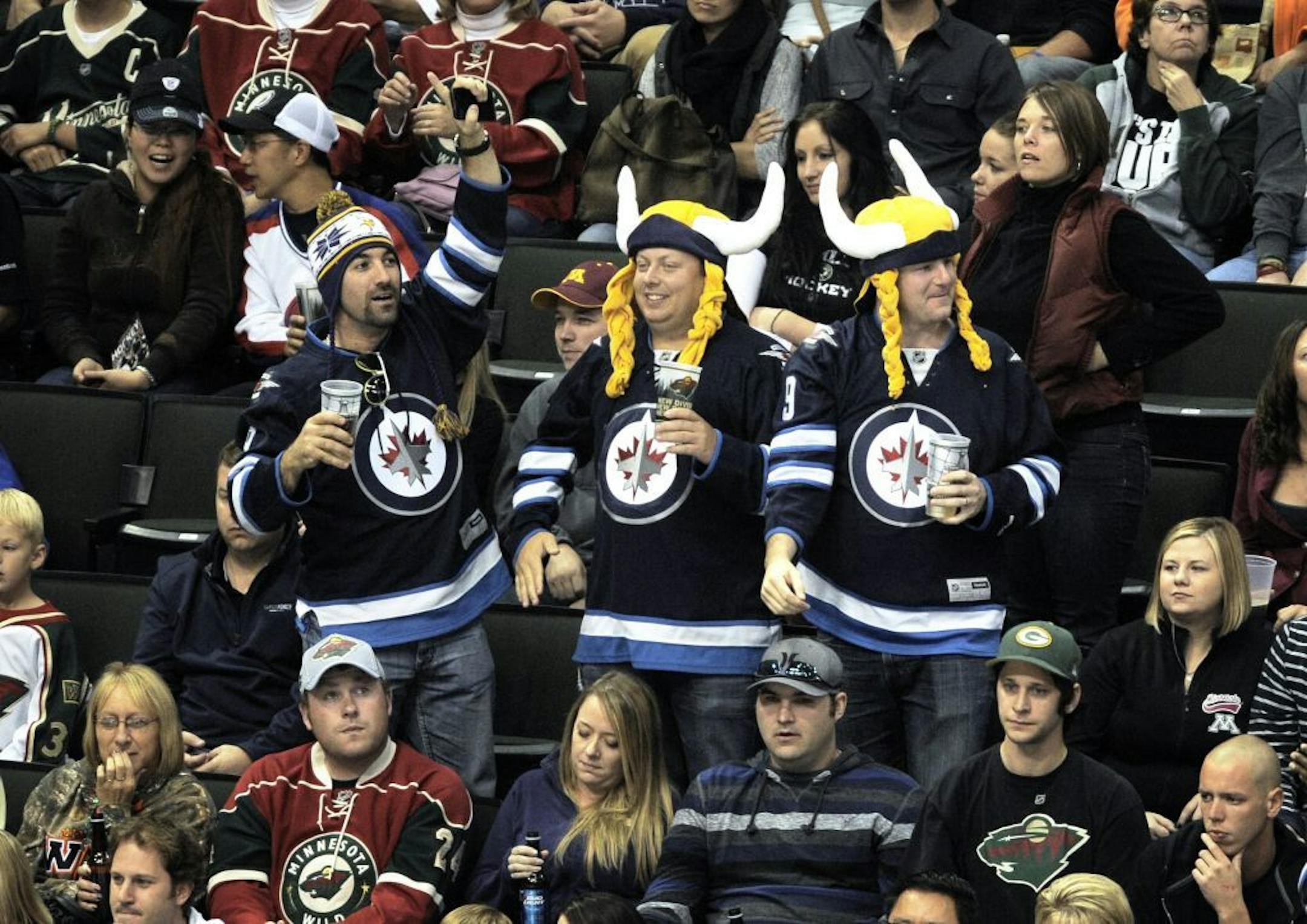 Winnipeg Jets fans wearing Minnesota Vikings headgear celebrate a goal by the Jets during a preseason game at the X last month.