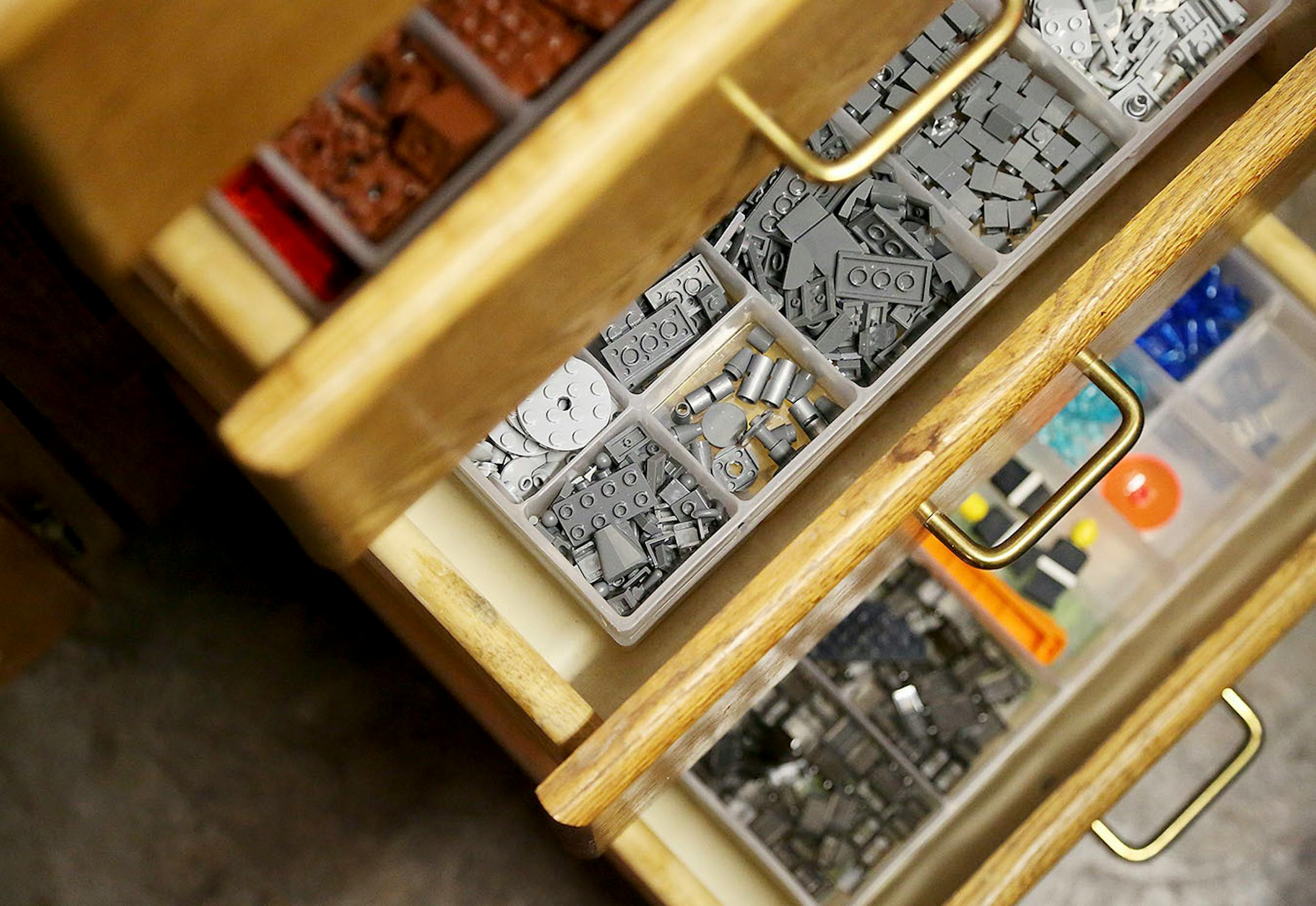 Esler his Lego supplies in drawers in his work space.