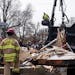 Firefighters investigate the scene of an explosion on the 6400 block of Oliver Avenue South that leveled the house in Richfield on Monday.
