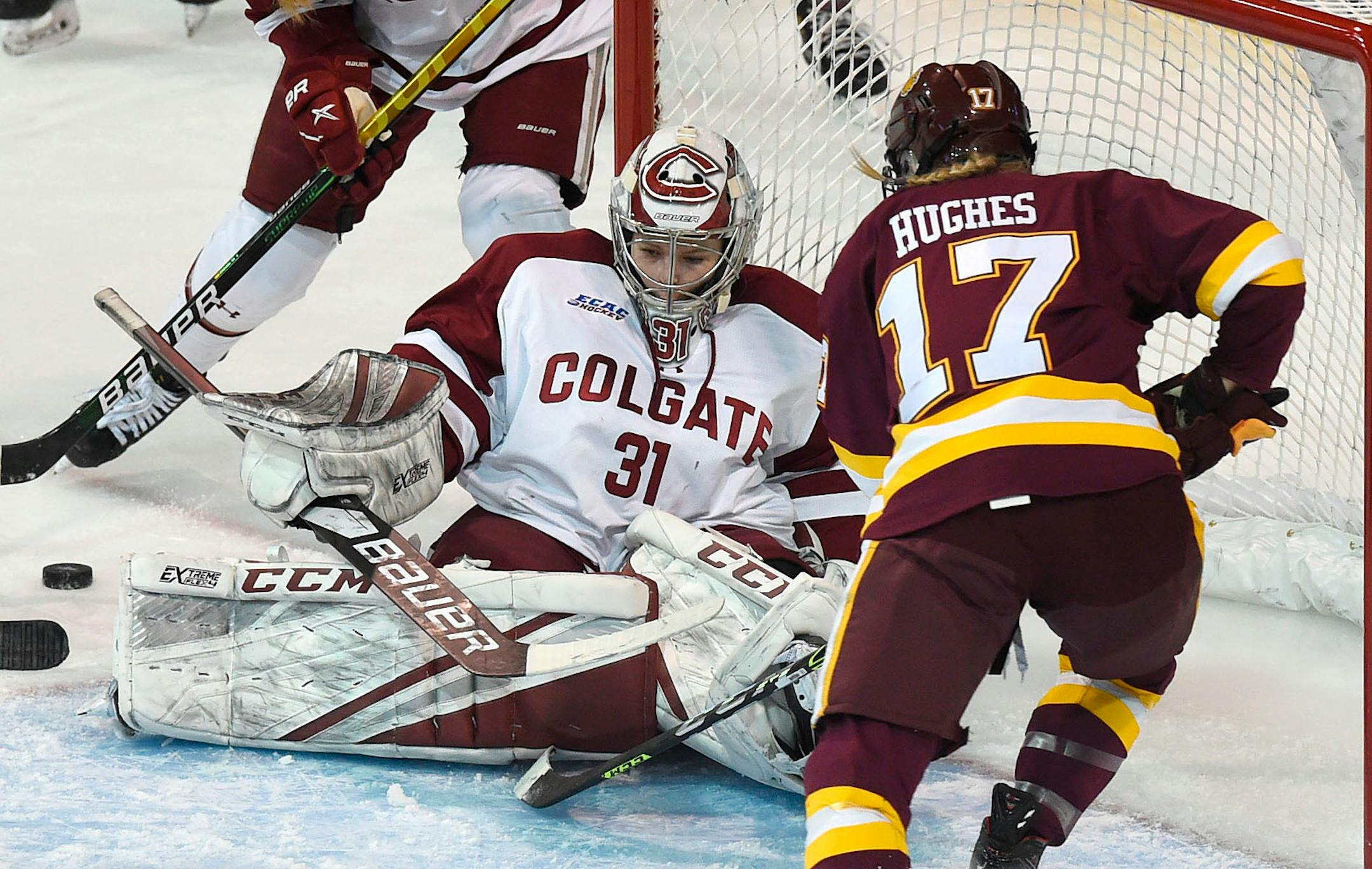 Colgate goalie Kayle Osborne makes a save on Minnesota-Duluth's Gabbie Hughes in the quarterfinals of the NCAA college women's hockey championships, Monday, March 15, 2021, at Erie Insurance Arena, in Erie, Pa. (Jack Hanrahan/Erie Times-News via AP)