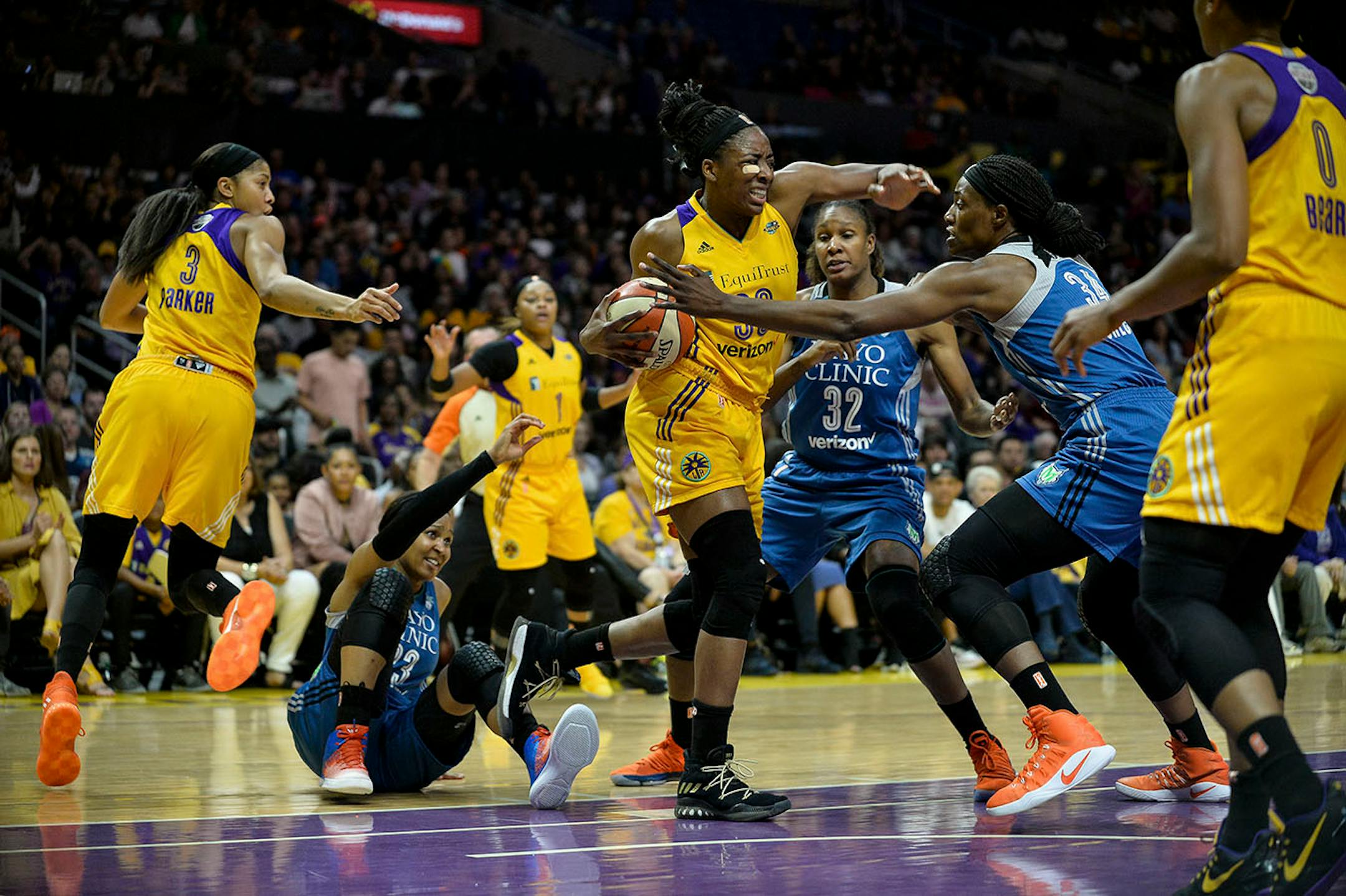 Los Angeles Sparks forward Nneka Ogwumike (30) won a defensive rebound battle as Minnesota Lynx forward Maya Moore (23) picked herself off the court in the first half Sunday.
