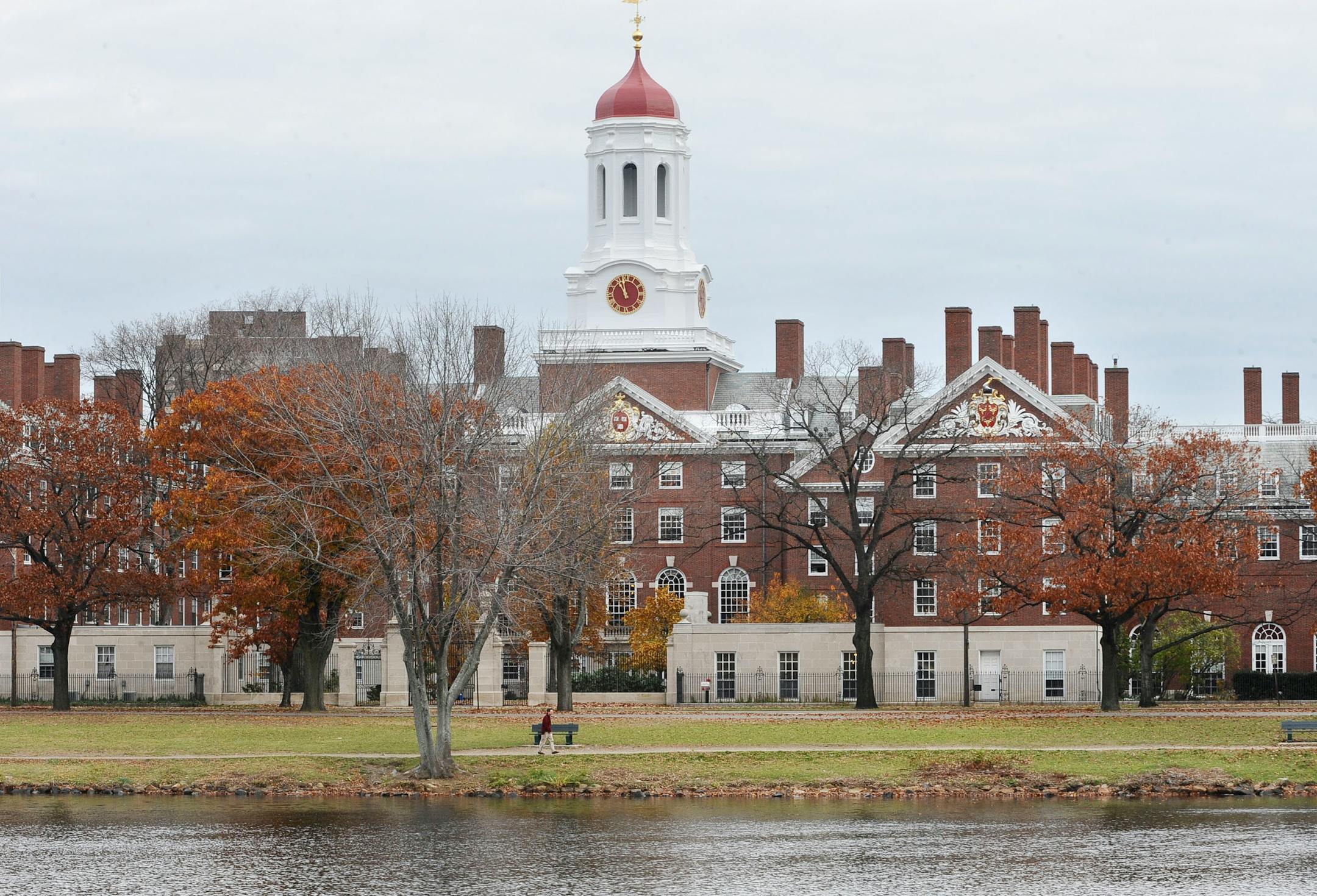Buildings with a pond in the foreground in late fall.