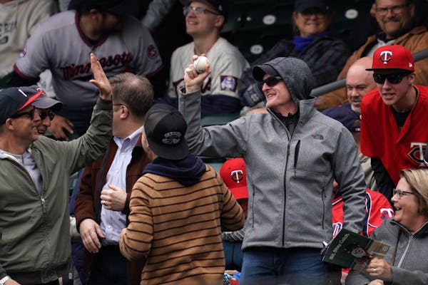 A Twins fan celebrated after catching a foul ball in the stands on May 2