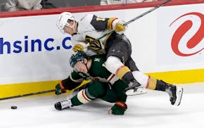 Vegas' Pavel Dorofeyev tangles with the Wild's Matt Boldy in the third period Saturday at Xcel Energy Center.