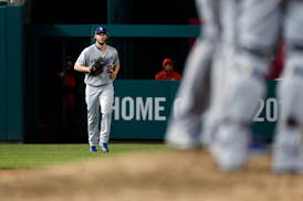 Los Angeles Dodgers starting pitcher Clayton Kershaw jogs to the pitcher's mound to relieve relief pitcher Kenley Jansen in the ninth inning of Game 5