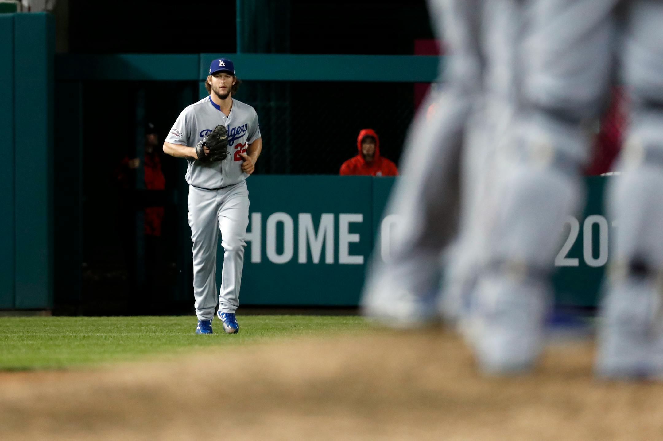 Los Angeles Dodgers starting pitcher Clayton Kershaw jogs to the pitcher's mound to relieve relief pitcher Kenley Jansen in the ninth inning of Game 5 of baseball's National League Division Series against the Washington Nationals, at Nationals Park, Friday, Oct. 14, 2016, in Washington. The Dodgers won 4-3 to advance to the NLCS. (AP Photo/Alex Brandon)