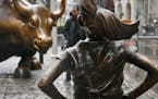 The "Fearless Girl" statue, created by Kristen Visbal, stands across from the "Charging Bull" statue, Monday, March 27, 2017, in New York. Mayor Bill 