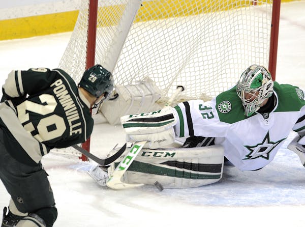 Dallas Stars' goalie Kari Lehtonen, right, of Finland, makes the pad save on Minnesota Wild's Jason Pominville (29) in the first period of an NHL hock