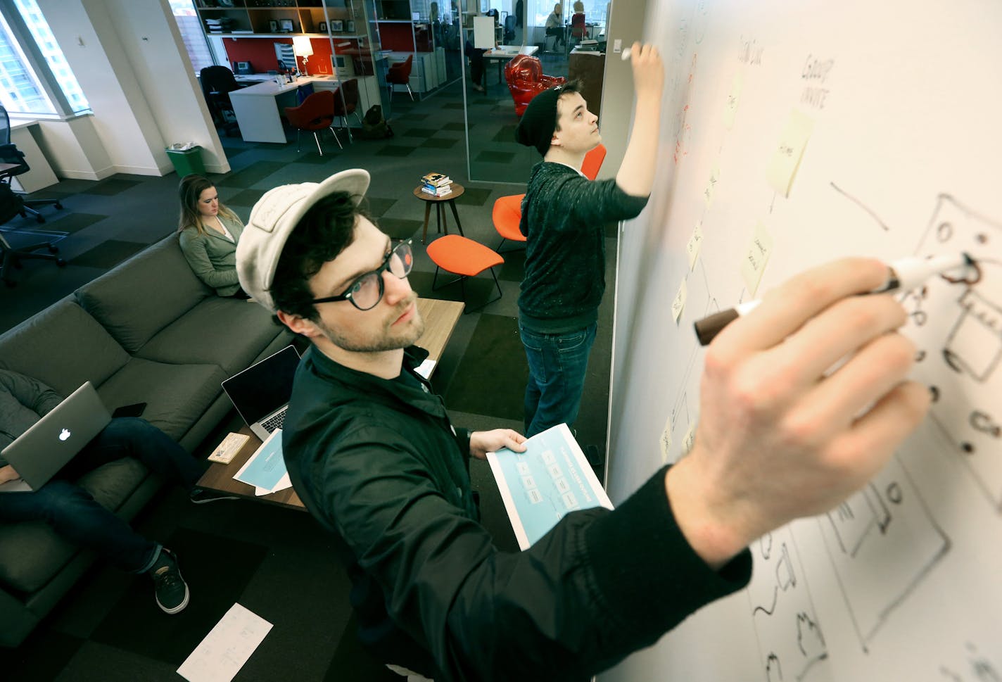 Rob Stone, foreground, and Tyler Dahl, creative staff at Fallon ad agency, mapped some ideas on a whiteboard at company headquarters last week.