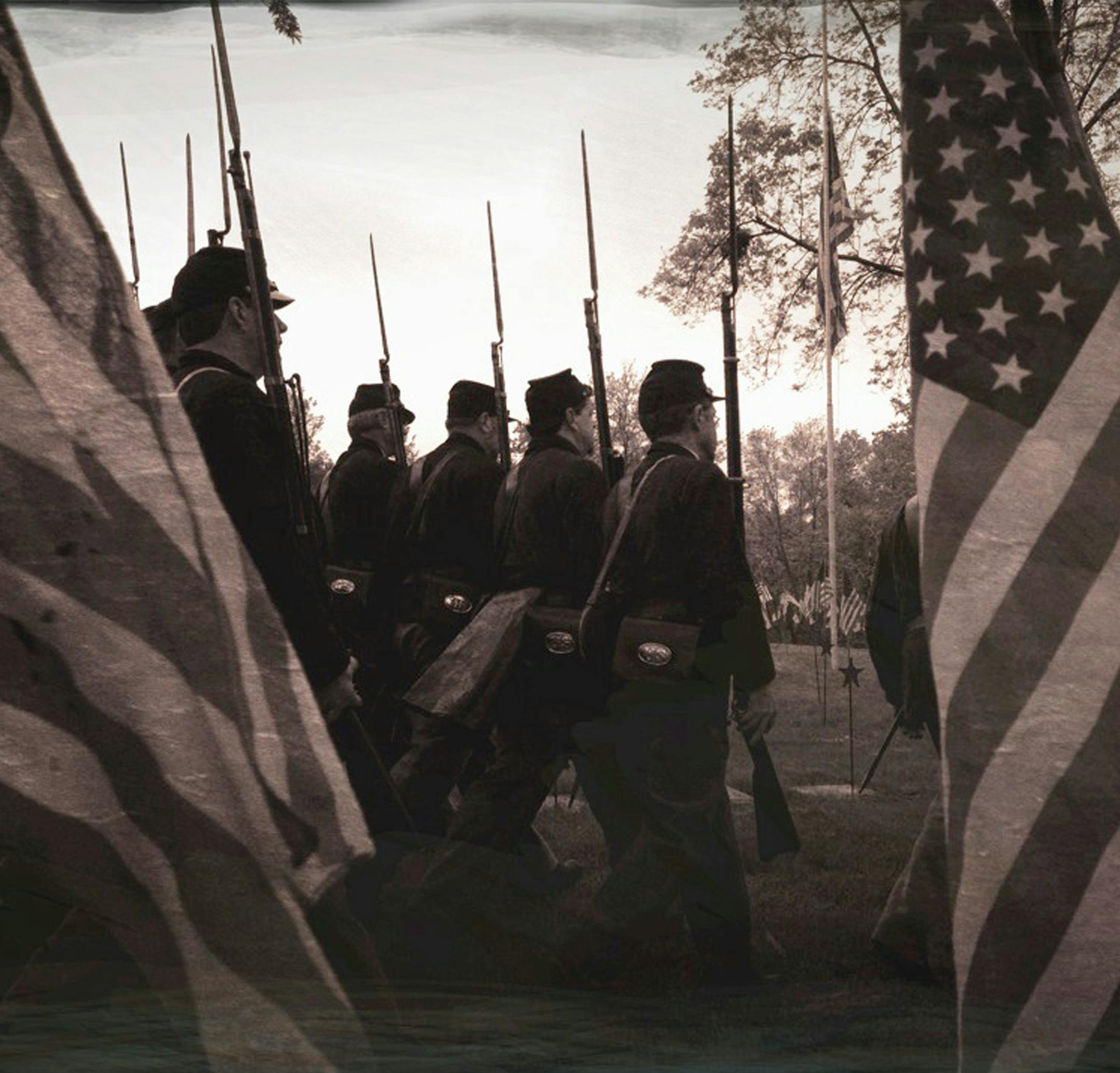 This year's Memorial Day service at Lakewood Cemetery paid honor to the 150th anniversary of the Civil War with Abraham Lincoln reenactor Kevin Koester reading the Gettysburg Address and the First and Second Minnesota Volunteer Infantries executing a rifle salute. This photo was taken using an iPhone and an app that recreates the look of a"tintype" photograph that was popular at the time. Monday, May 27, 2013 ] GLEN STUBBE * gstubbe@startribune.com ORG XMIT: MIN1305271419312781