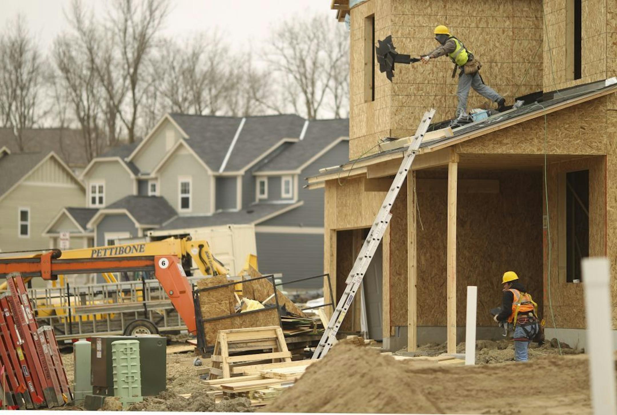Roofers from Midwestern Roofing Systems LLC were at work on a new home under construction on Merrimac Lane in Plymouth.