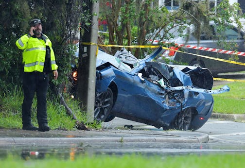 Law enforcement investigators in the scene of a fatal car crash on Roosevelt Blvd. in the Ortega neighborhood of Jacksonville, Fla. during the strong winds from Tropical Storm Elsa, Wednesday, July 7, 2021. (Bob Self/The Florida Times-Union via AP)