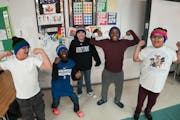 Some of Samantha Monson’s students struck their favorite superhero poses with their hats made by Samantha’s mother and sister in St. Paul middle s