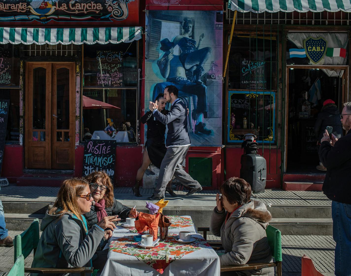 Fiorella Paglione and Eodrigo Barraza dance the tango in front of a restaurant in the El Caminito district of Buenos Aires, Argentina, July 6, 2019. A group of activists is trying to make tango less dogmatic about traditional gender roles, and more assertive about rooting out sexual harassment and assault. (Victor Moriyama/The New York Times) -- STANDALONE IMAGE FOR USE AS DESIRED WITH YEAREND ROUNDUPS -- ORG XMIT: NYT021