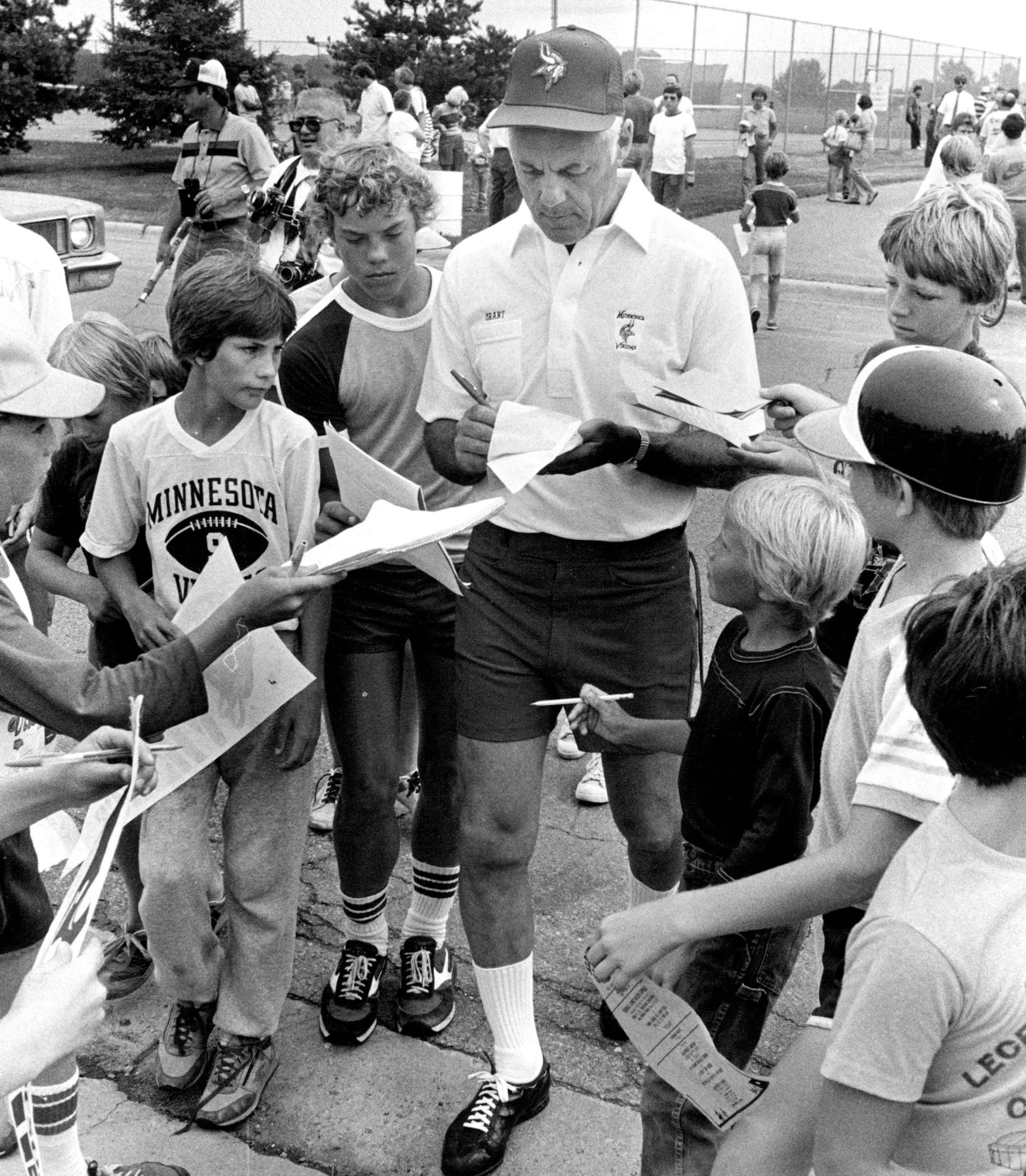 Minnesota Vikings Coach Bud Grant signed autographs at training camp on July 27, 1983.