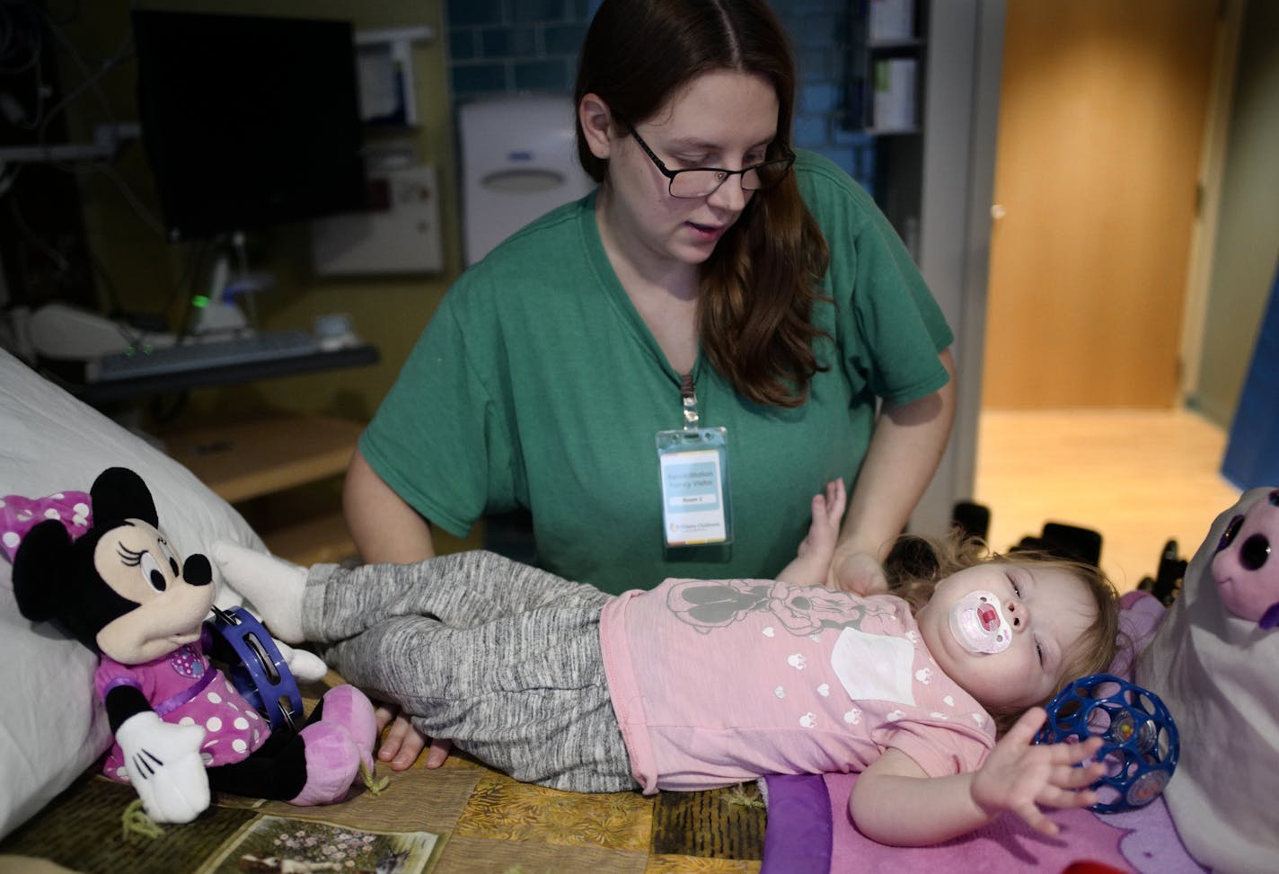 Haley Long helps place her daughter Aria into her hospital bed. She has partial paralysis in her left leg caused by AFM.] The emergence of a Minnesota cluster of AFM, a polio-like disorder that causes paralysis in small children, has gained national attention. Now children in that cluster are taking varying routes to treatment, because the best methods are unknown or unproven. Intensive physical therapy seems to help some children recover lost mobility in their arms and legs.Richard Tsong-Taatar