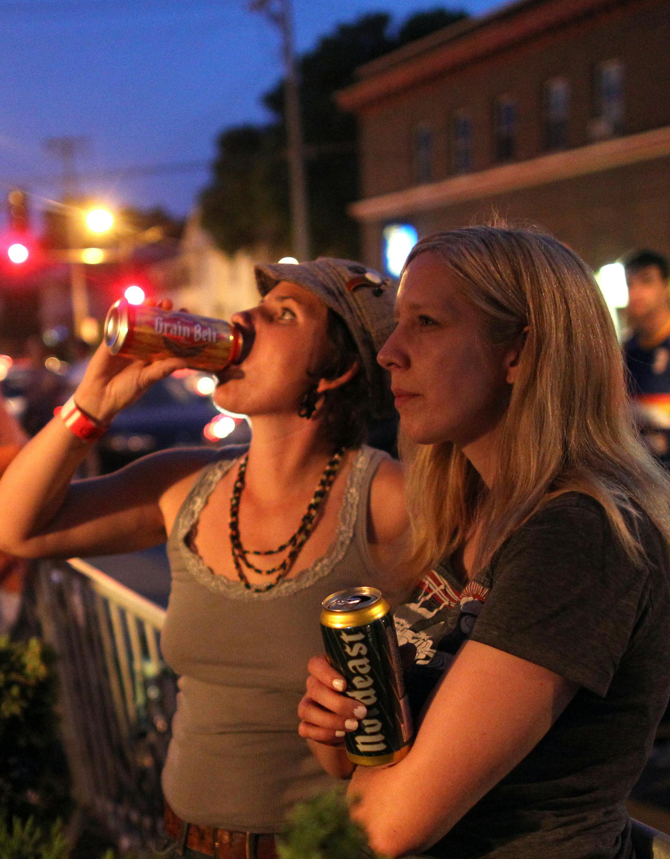 Rebecca Yoshirio, left, and Tiffany Ralstan listened to Vicious Vicious perform outside the 331 club tent during Art-A-Whirl 2012. Art-a-Whirl takes place annually in northeast Minneapolis the third weekend of May.