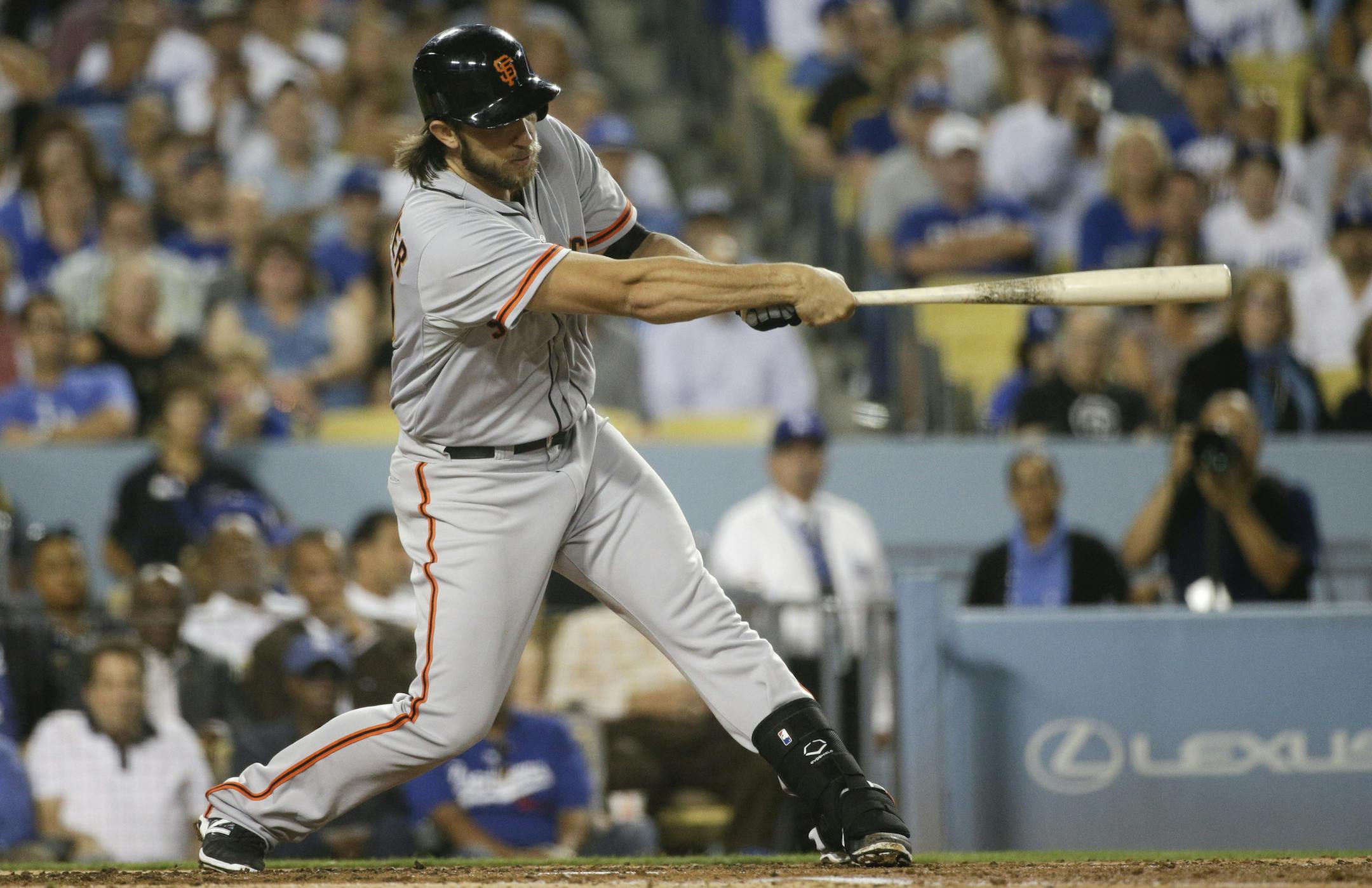 San Francisco Giants starting pitcher Madison Bumgarner hits a two-run home run during the third inning of a baseball game against the Los Angeles Dodgers Tuesday, Sept. 23, 2014, in Los Angeles. (AP Photo/Jae C. Hong) ORG XMIT: NYOTK