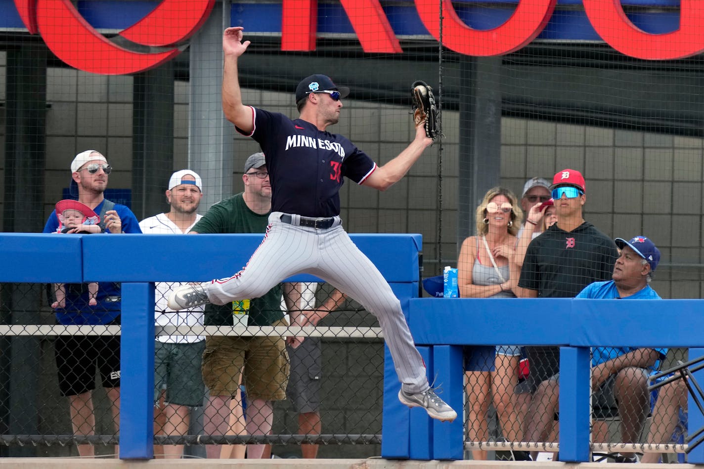 Twins right fielder Matt Wallner makes a leaping catch on a fly-put by Toronto's George Springer during a spring training game March 8