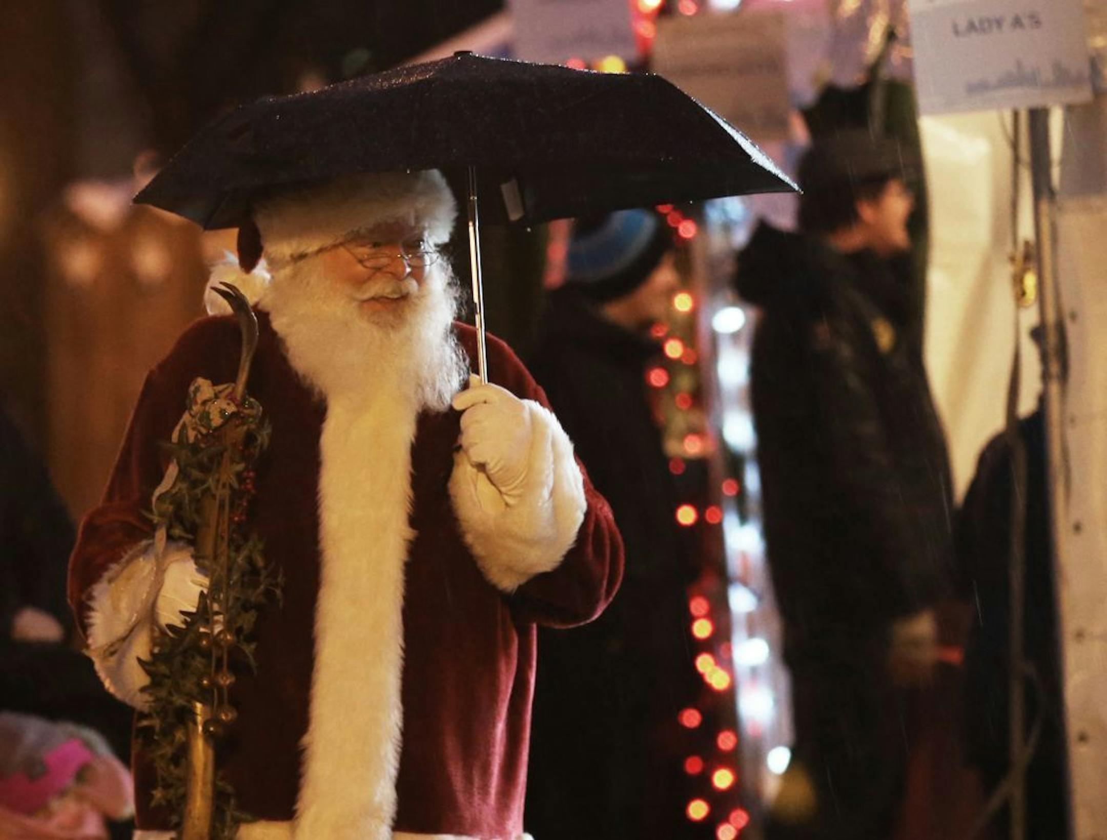 Holidazzle kicked off at Friday, Nov. 23, 2018, at Loring Park in Minneapolis, MN. Here, Santa sported an umbrella while briefly strolling the Holidazzle grounds.