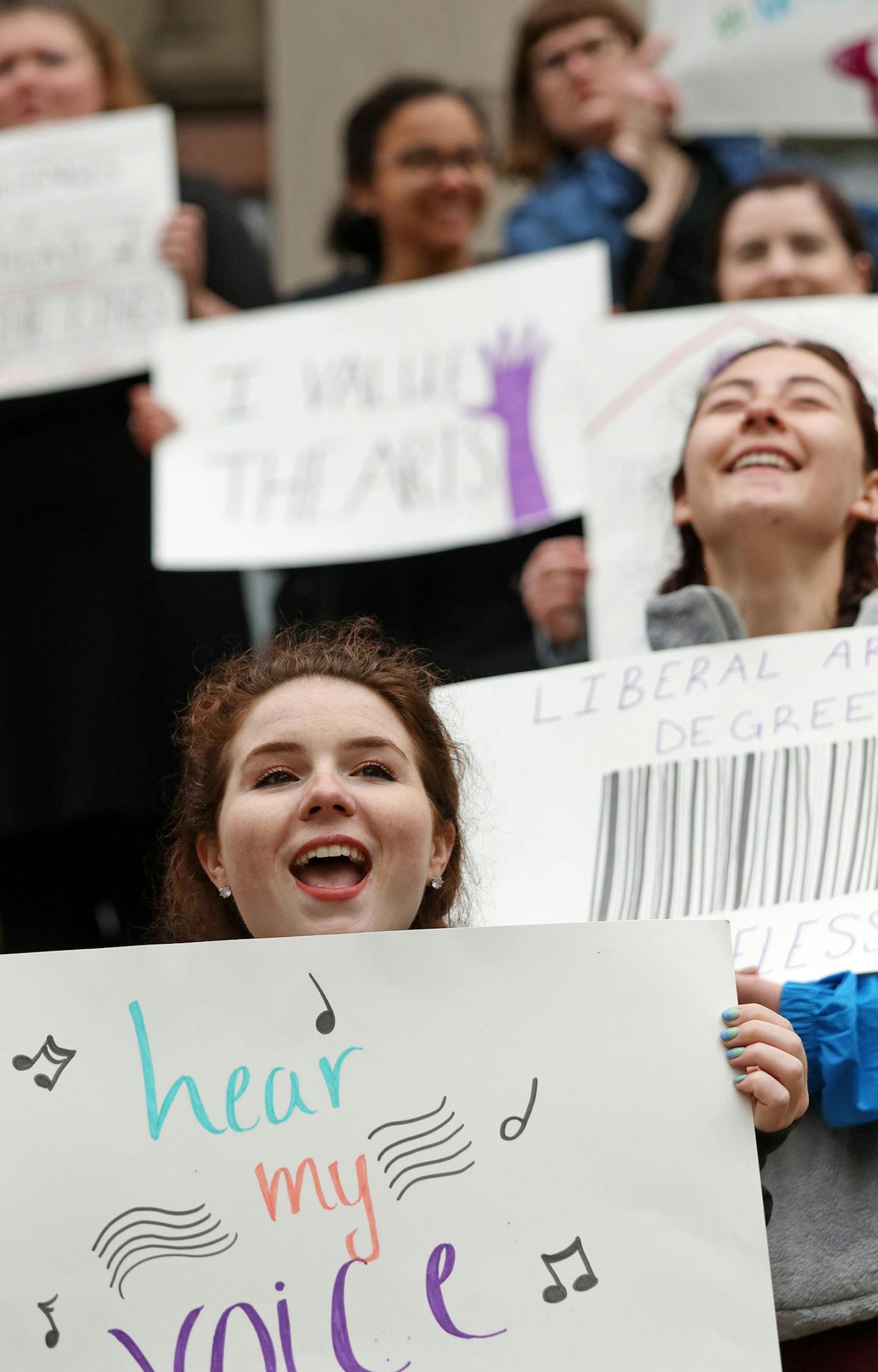 Jordan Lena, center, sang along with her fellow protesters in front of Derham Hall opposing cuts to the music and theater programs Thursday. ] ANTHONY SOUFFLE &#xef; anthony.souffle@startribune.com Protesters, including choir, soloists, instrumentalists and actors, participated in a protest "sing"-in Thursday, May 18, 2017 in and around Derham Hall opposing cuts to the music and theater programs at St. Catherine University in St. Paul, Minn.