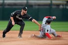 White Sox shortstop Paul DeJong gets the tag down too late to catch the Twins' Christian Vázquez stealing second base during the seventh inning Monda