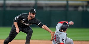 Chicago White Sox shortstop Paul DeJong, left, cannot catch Minnesota Twins' Christian Vázquez stealing second base during the seventh inning on Mond
