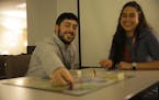 Shawn McLaughlin, left, and Ilana Stern play "Ungame," a board game used to create a positive environment and discuss personal life between students, 