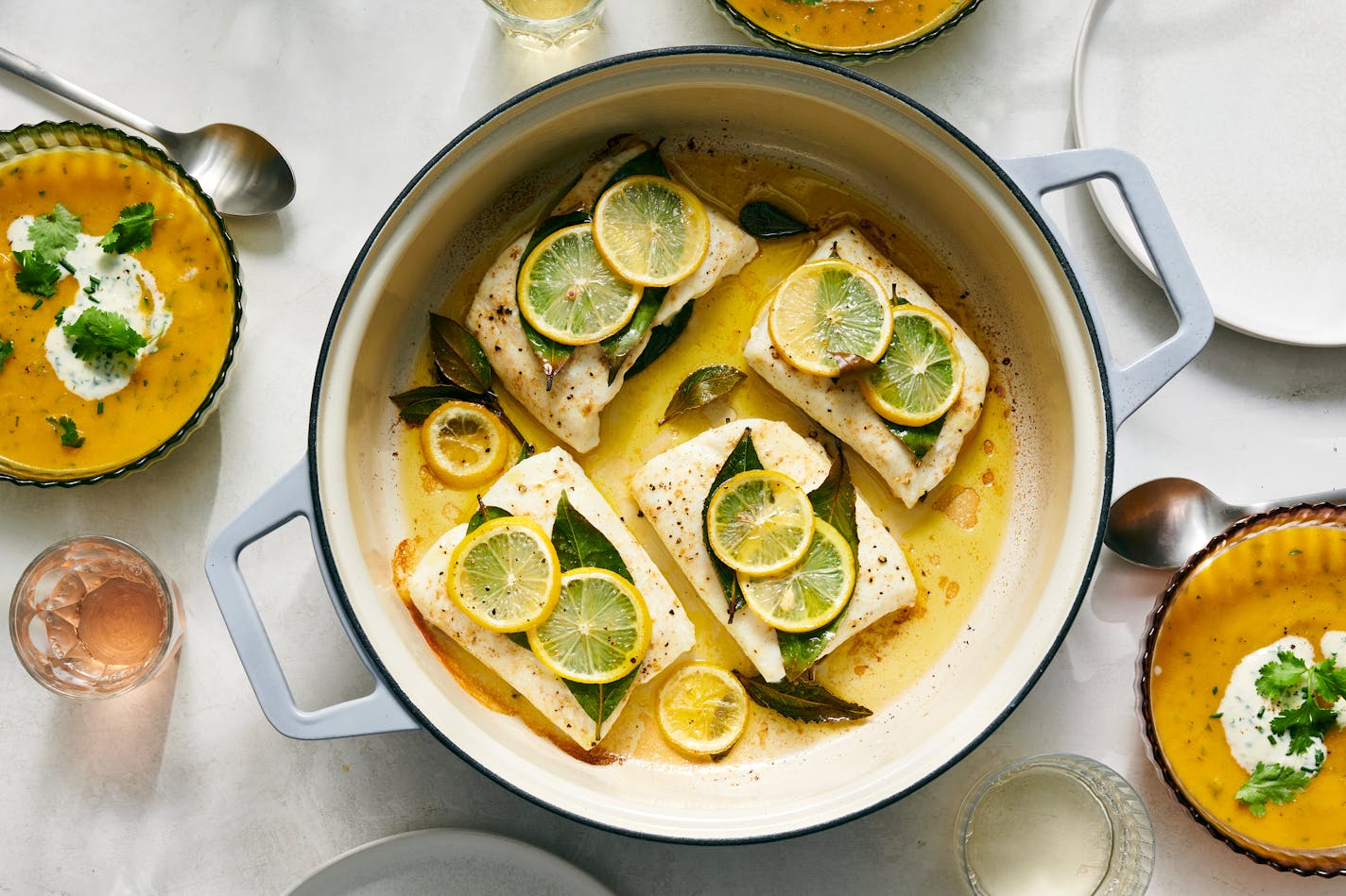 Roasted fish with cumin, lemon and bay, center, and spicy carrot-ginger soup. Impress your friends without much effort with this menu from David Tanis: a spiced carrot soup, a roasted fish with lemon and a lovely orange-pomegranate finish. Food styled by Simon Andrews. (David Malosh/The New York Times)