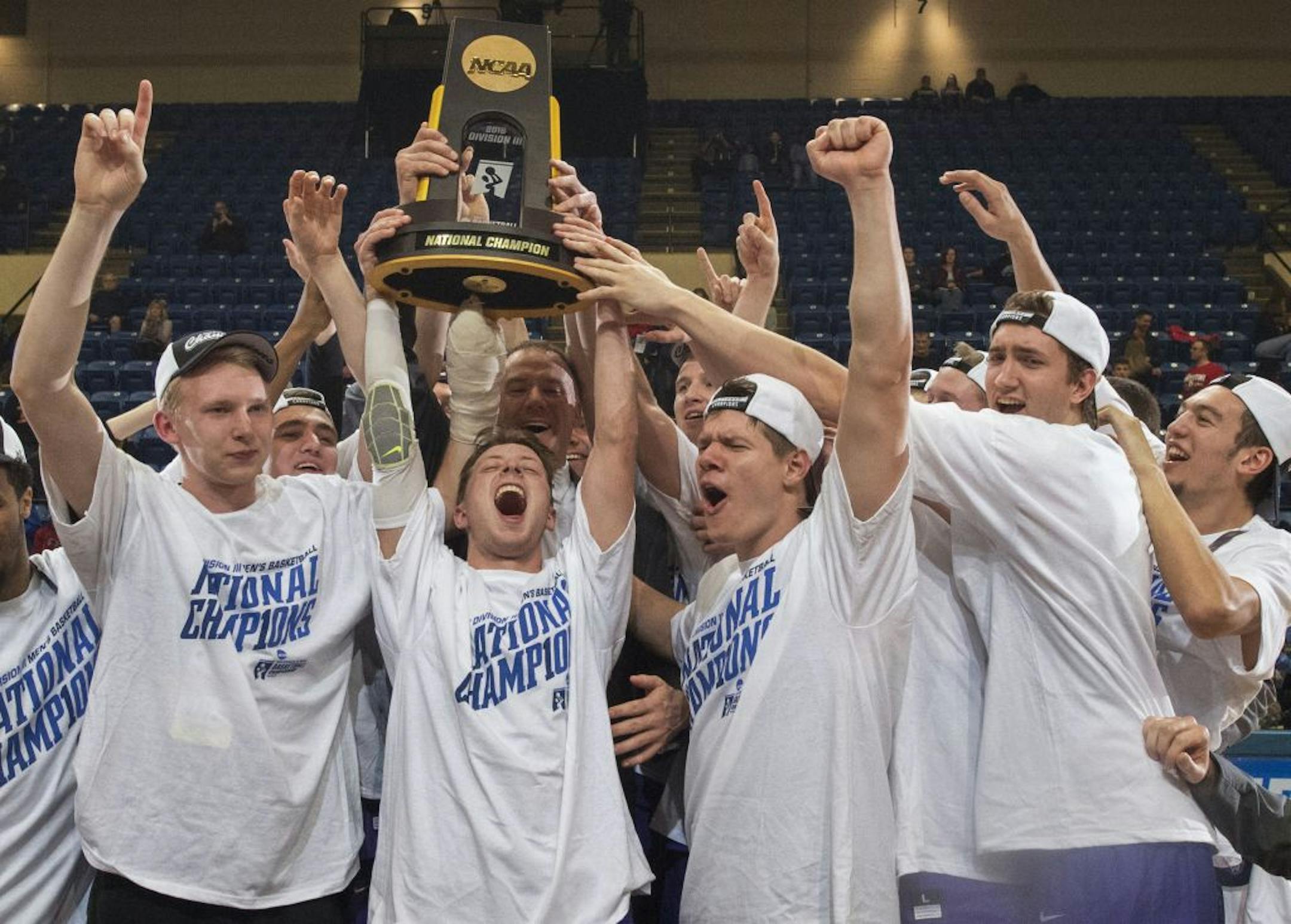 FILE - In this March 19, 2016, file photo, St. Thomas players, from left, Thomas Sjoberg, Grant Shaeffer, Will Dunn, Jodan Burich and G.T. Johnson celebrate after St. Thomas won NCAA Division III men's college basketball championship game 82-76 over Benedictine in Salem, Va. The NCAA has given the University of St. Thomas permission to move its sports teams directly from Division III to Division I. The Tommies were granted a waiver to bypass the current reclassification rules that require a stop