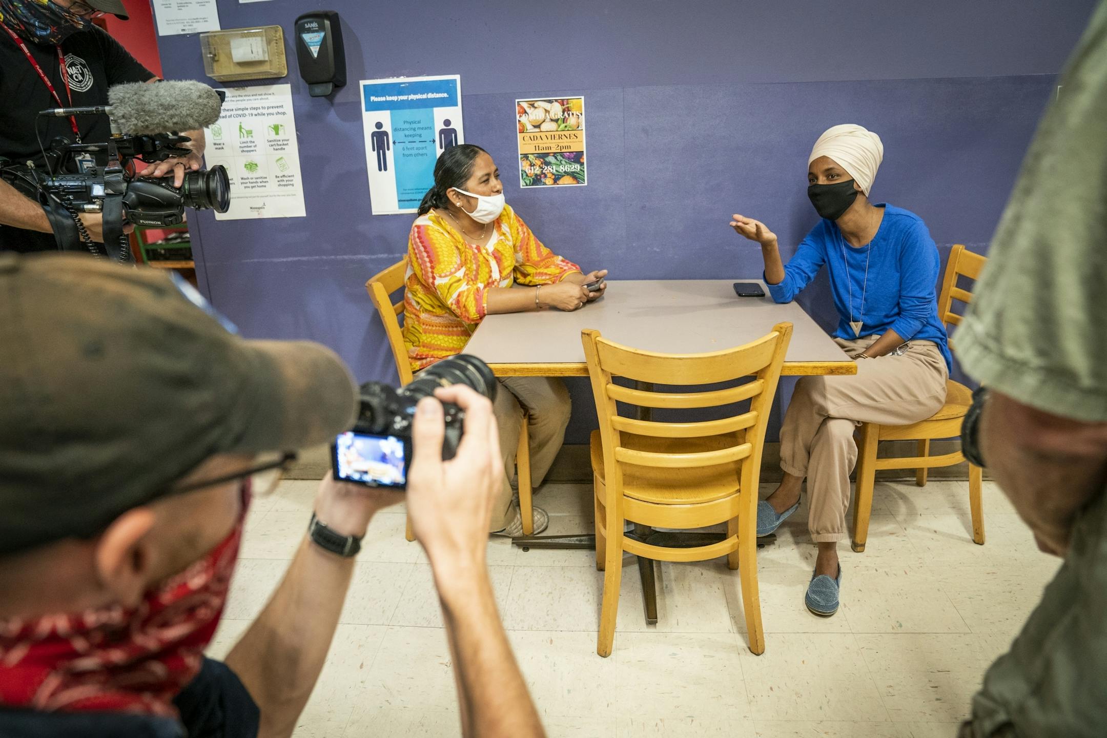 U.S. Rep. Ilhan Omar talked with Laura Sanchez, owner of Isabella's Grocery at Mercado Central in Minneapolis, during a get out the vote stop on Primary Election Day.
