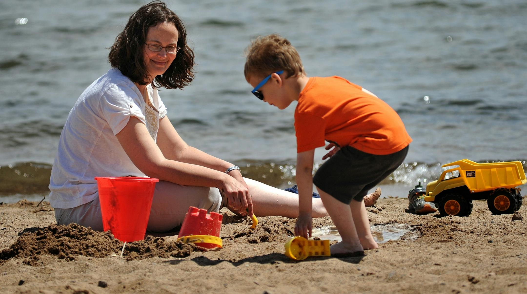 Kristin Kruschke and her 3 1/2-year-old son Evan worked on a construction project in the sand of Lake Minnetonka in Wayzata.