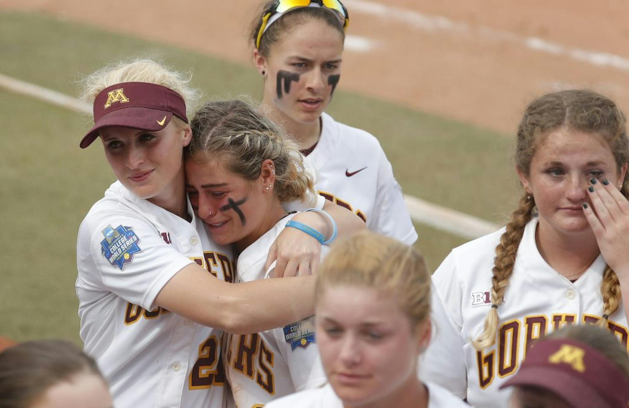 Minnesota's Allie Allie Arneson, center, is emotional following the loss to Washington during the Women's College World Series at ASA Hall of Fame Stadium in Oklahoma City on Saturday, June 1, 2019. Washington won 5-3. Photo by: Alonzo J. Adams