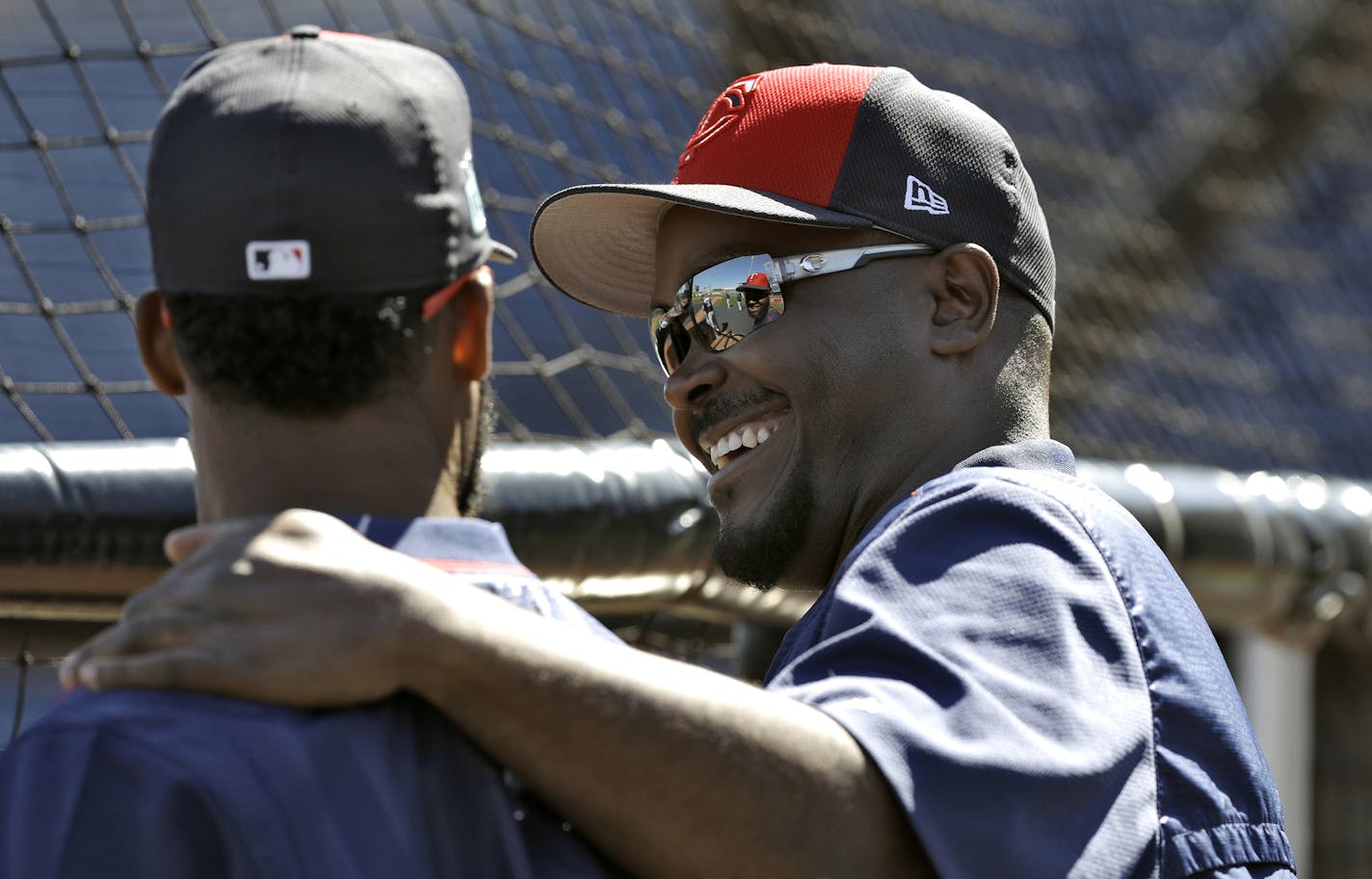 Minnesota Twins hitting coach James Rowson, right, laughs as he talks to center fielder Danny Santana before a spring training baseball game against the Philadelphia Phillies Friday, March 3, 2017, in Clearwater, Fla. (AP Photo/Chris O'Meara)