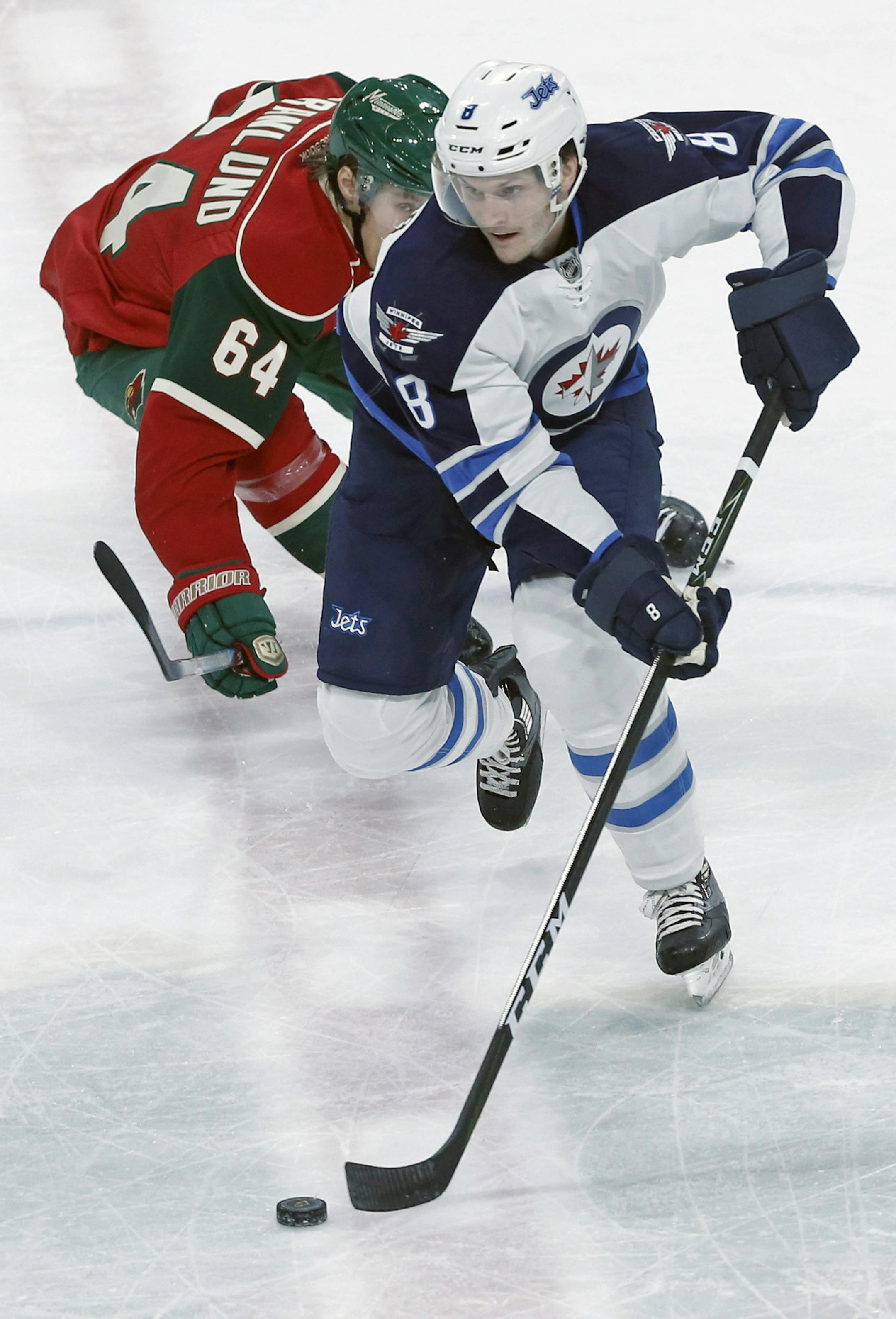The Wild’s Mikael Granlund, left, pursued Winnipeg’s Jacob Trouba during the first period Wednesday night at the Xcel Energy Center.