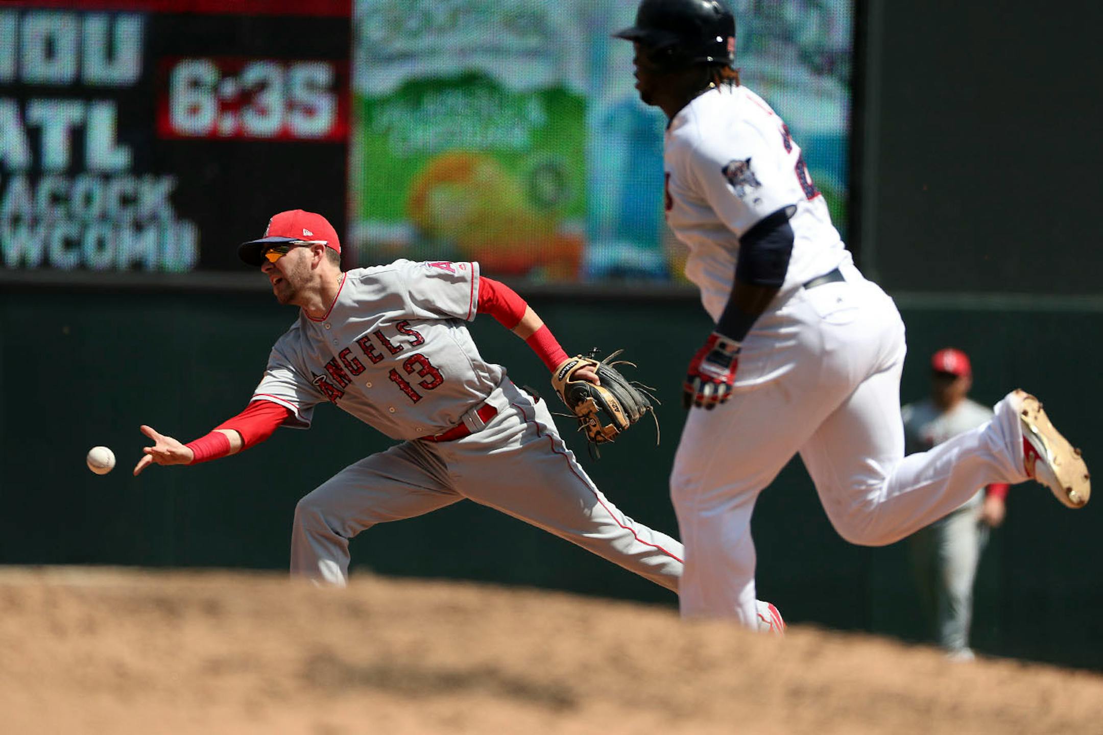 Los Angeles Angels left fielder Nick Franklin (13) threw the ball to second as Minnesota Twins third baseman Miguel Sano (22) raced down the baseline in the fifth inning.