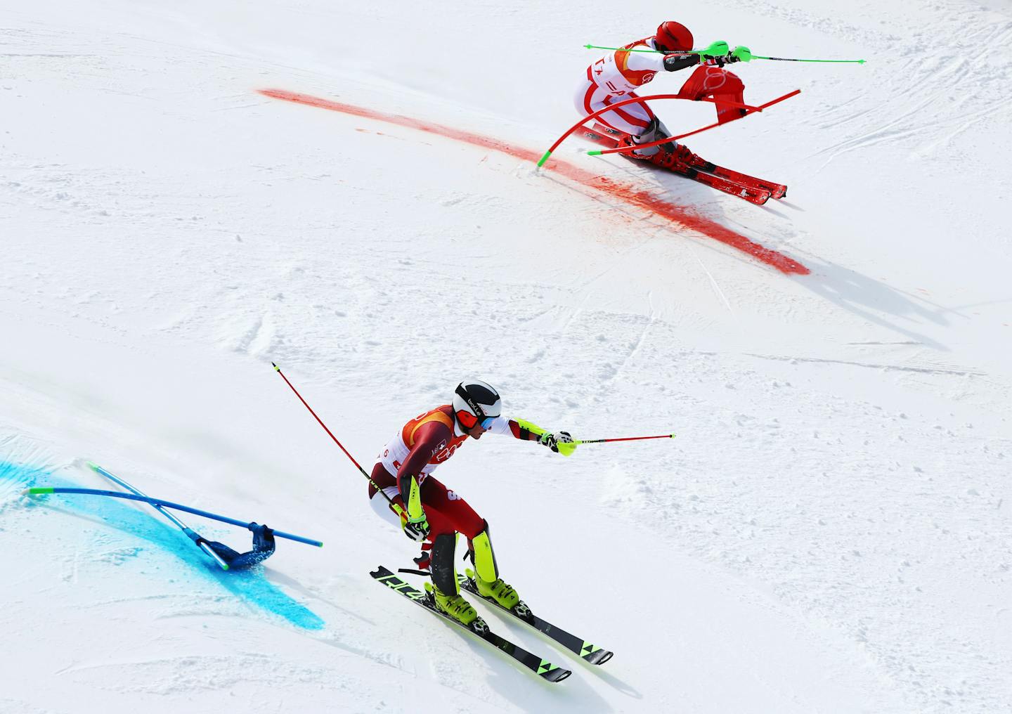 Switzerland's Daniel Yule, bottom, leads Austria's Marco Schwarz on his way to clinching the gold medal in the alpine team event at the 2018 Winter Olympics in Pyeongchang, South Korea, Saturday, Feb. 24, 2018. (AP Photo/Alessandro Trovati)