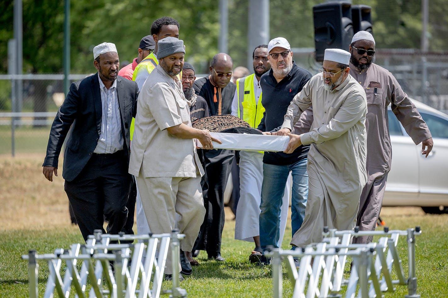 During the funeral at the Dar Al-Farooq Islamic Center in Bloomington on Monday, men carried the body of one of the five women killed in a car crash on Lake Street.