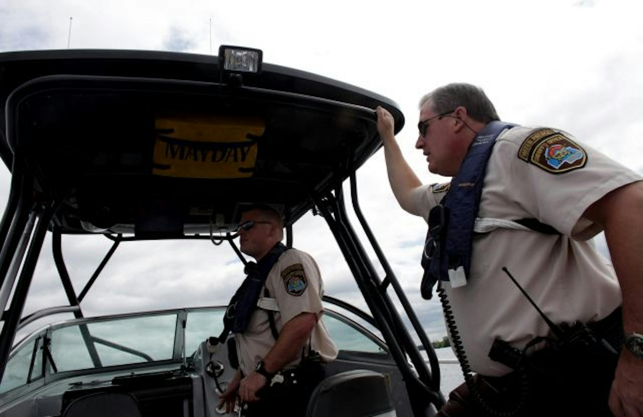 Hennepin County Water Patrol turns 50[Hennepin County Special deputies Jayson Johnson, left, and Rich Siakel took a look at the traffic on Lake Minnetonka.